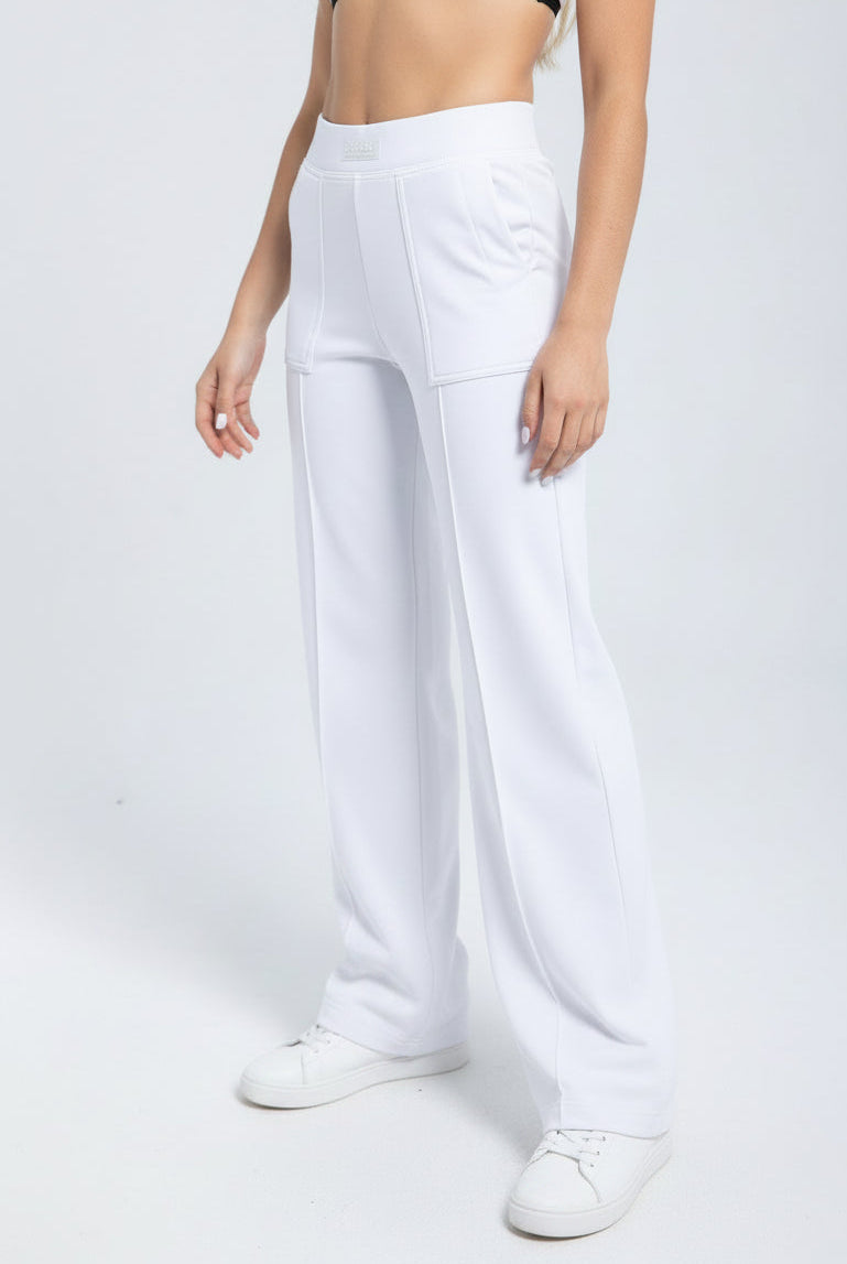 Person wearing white wide-leg pants on a plain background