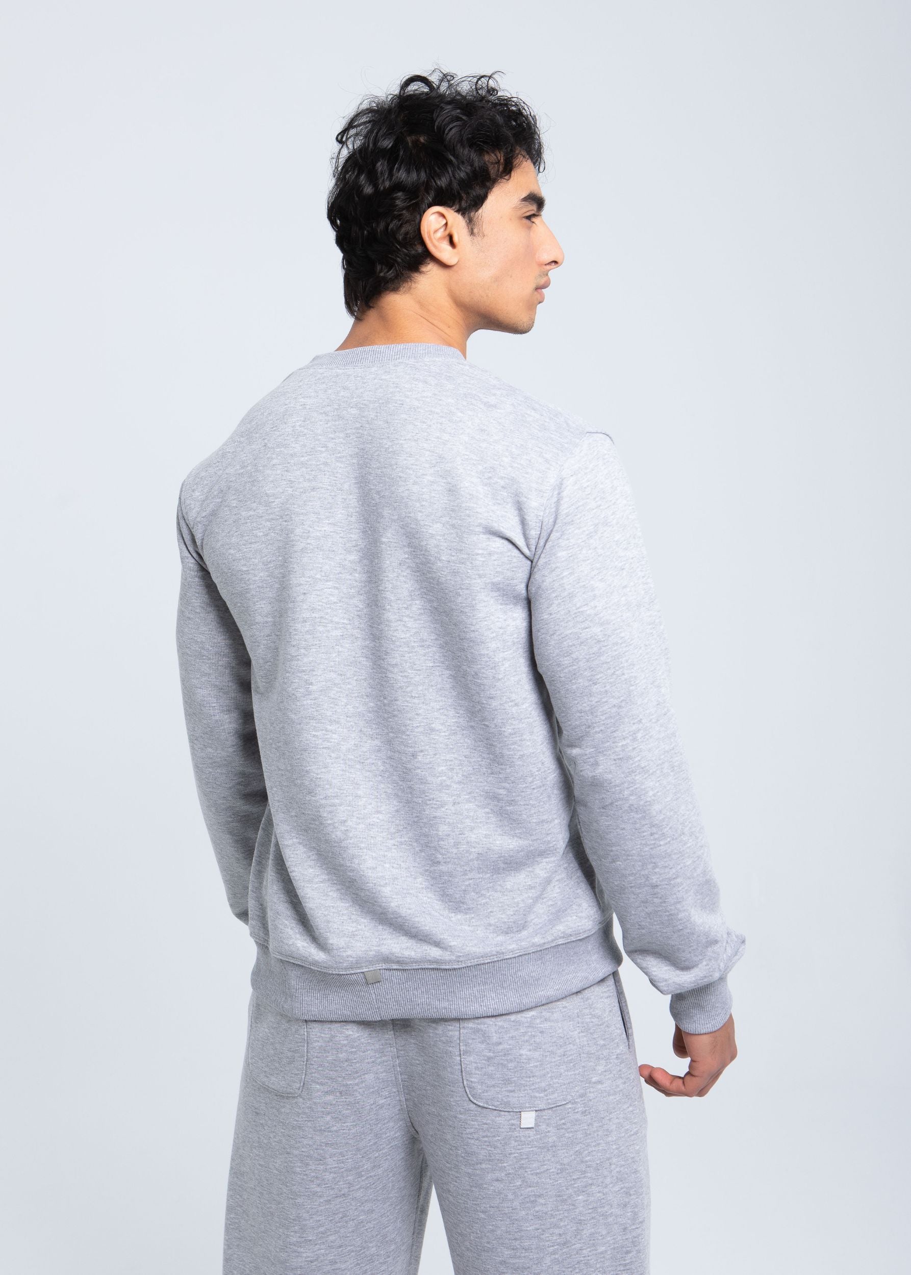 Back view of essential fleece crewneck with ribbed hem