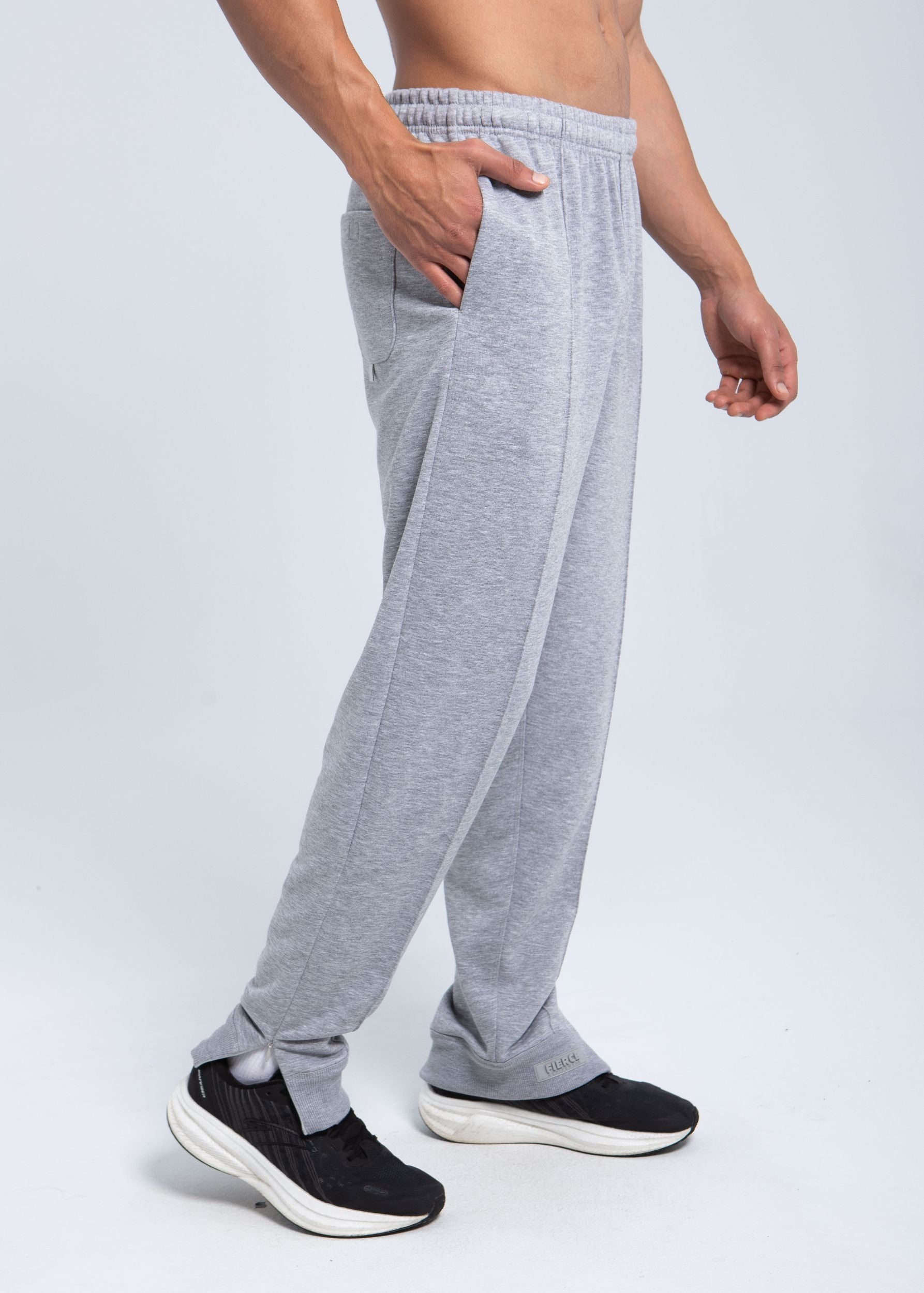 Side view of pleated fleece pants showing zip detail at hem