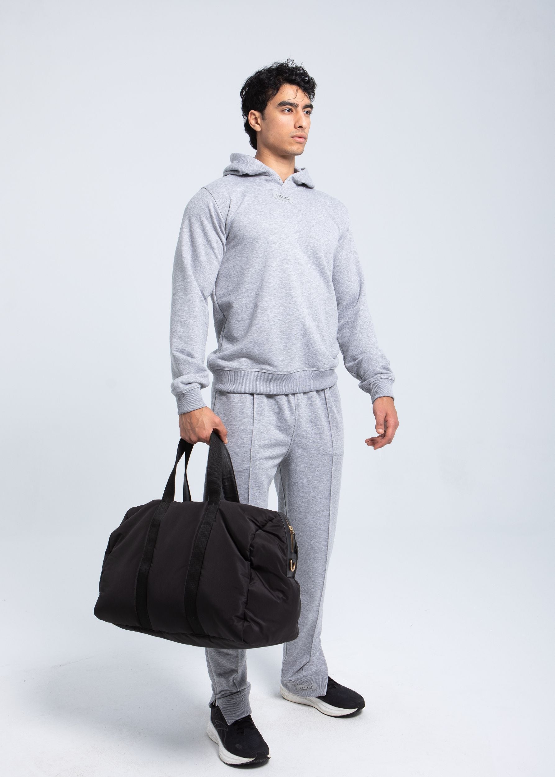 Full body look wearing heather grey fleece hoodie
