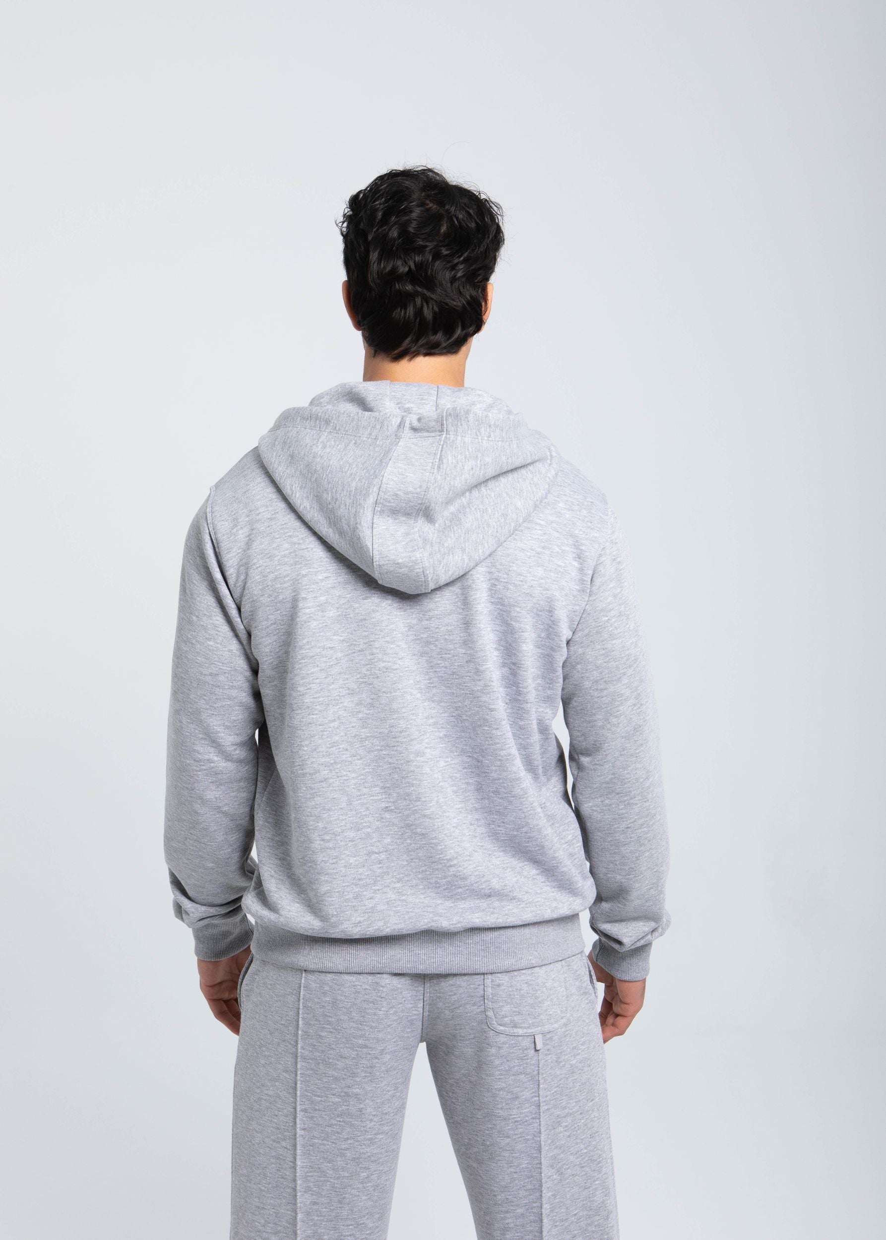 Essential hoodie back view showing adjustable hood