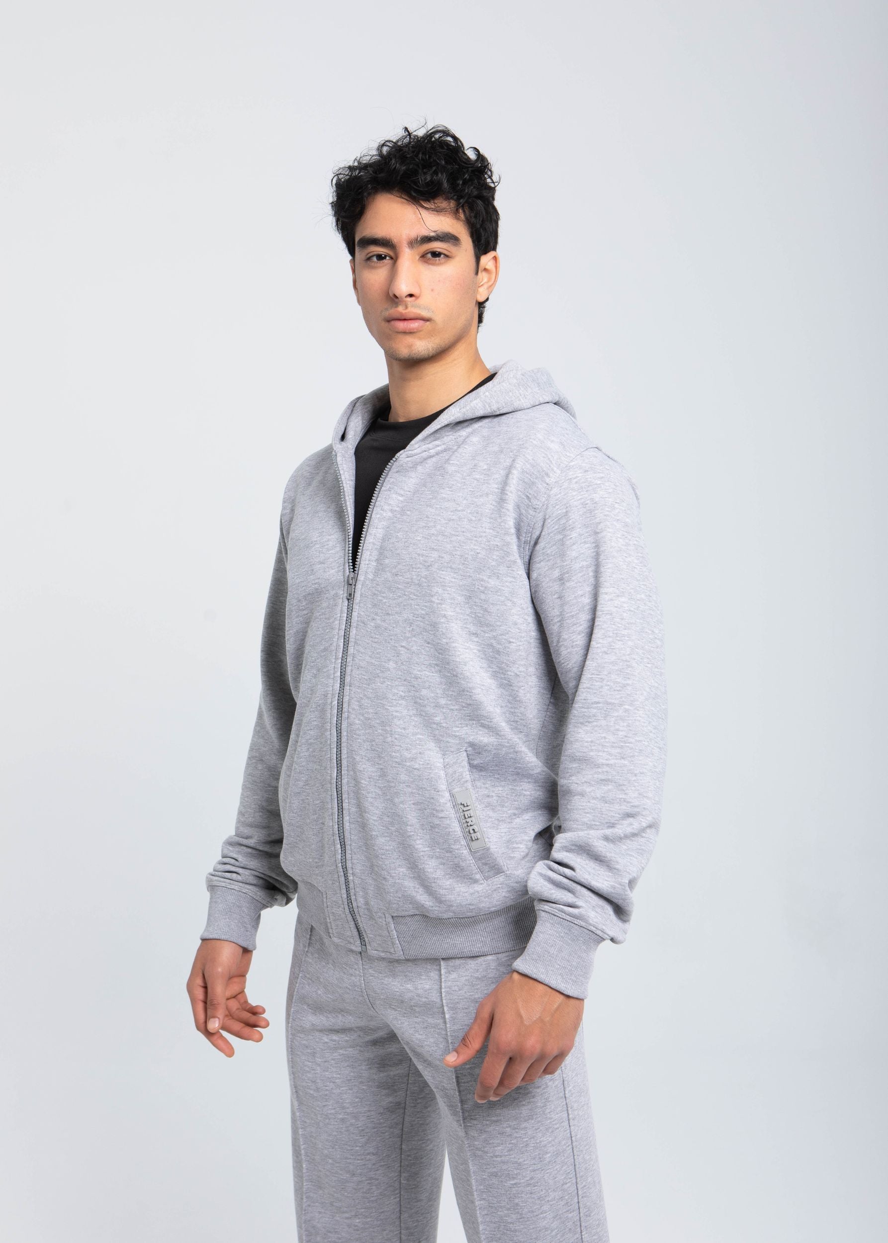Men’s full-zip hoodie angled side view with ribbed cuffs