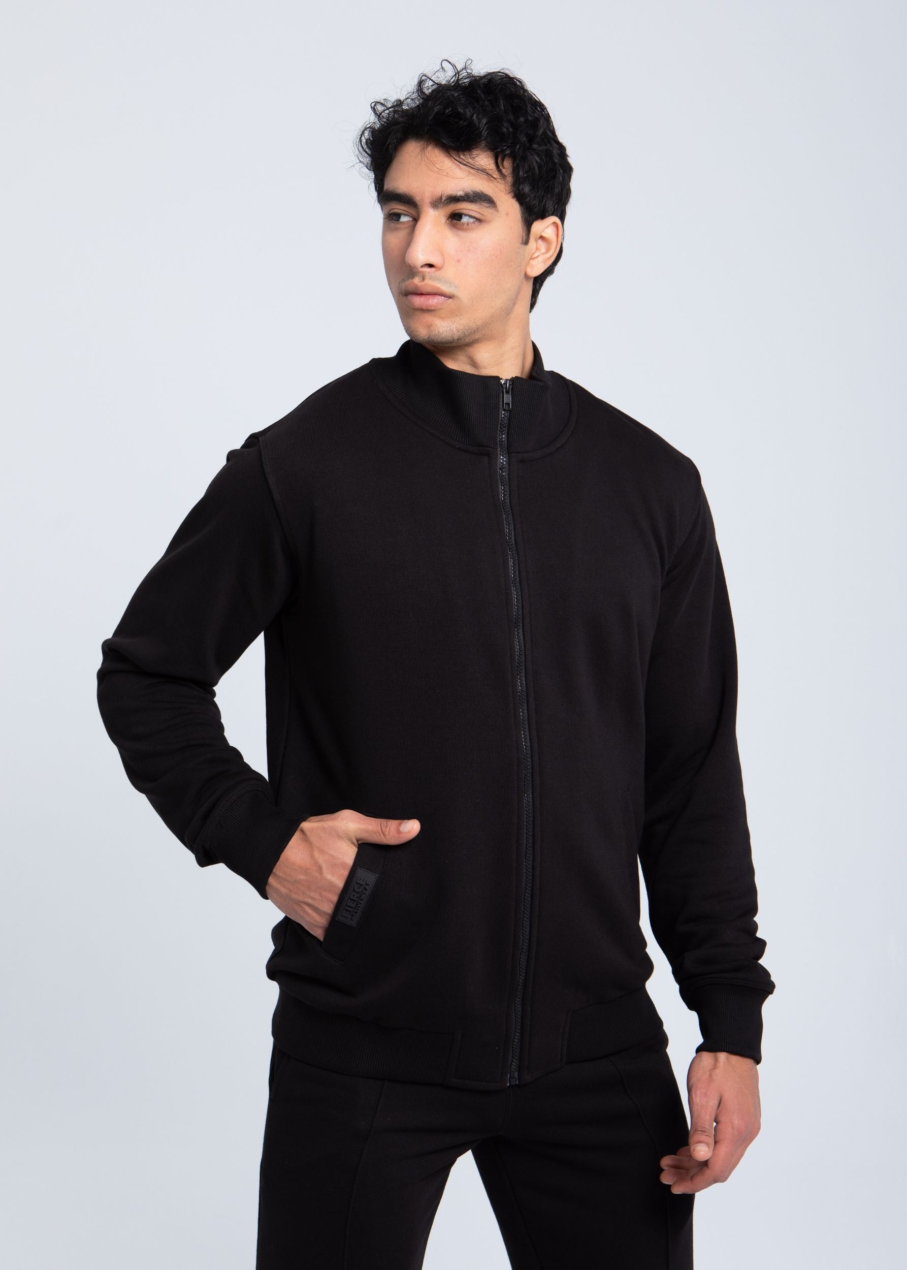 Black full-zip sweatshirt angled view with side pocket detail