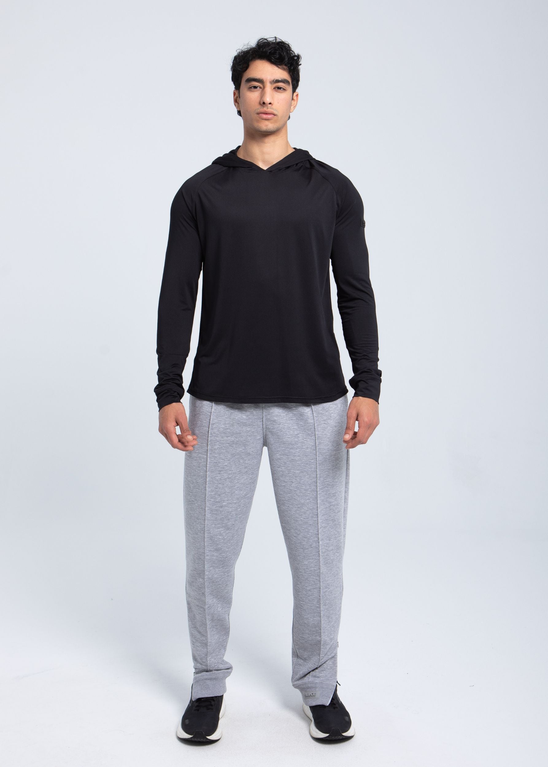 Full body view of men’s active hooded performance shirt in black