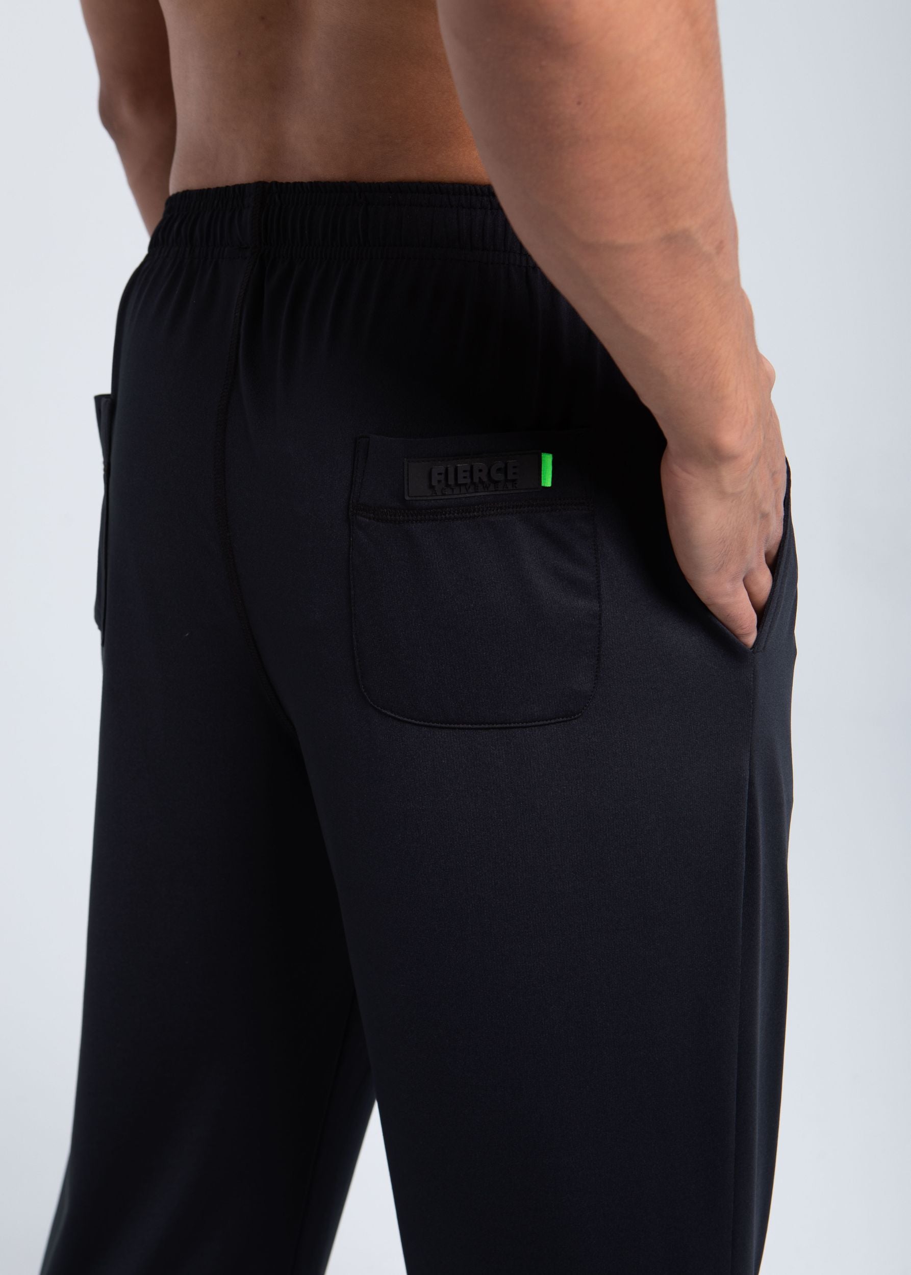 Close-up of back pocket detail with FIERCE logo and green accent